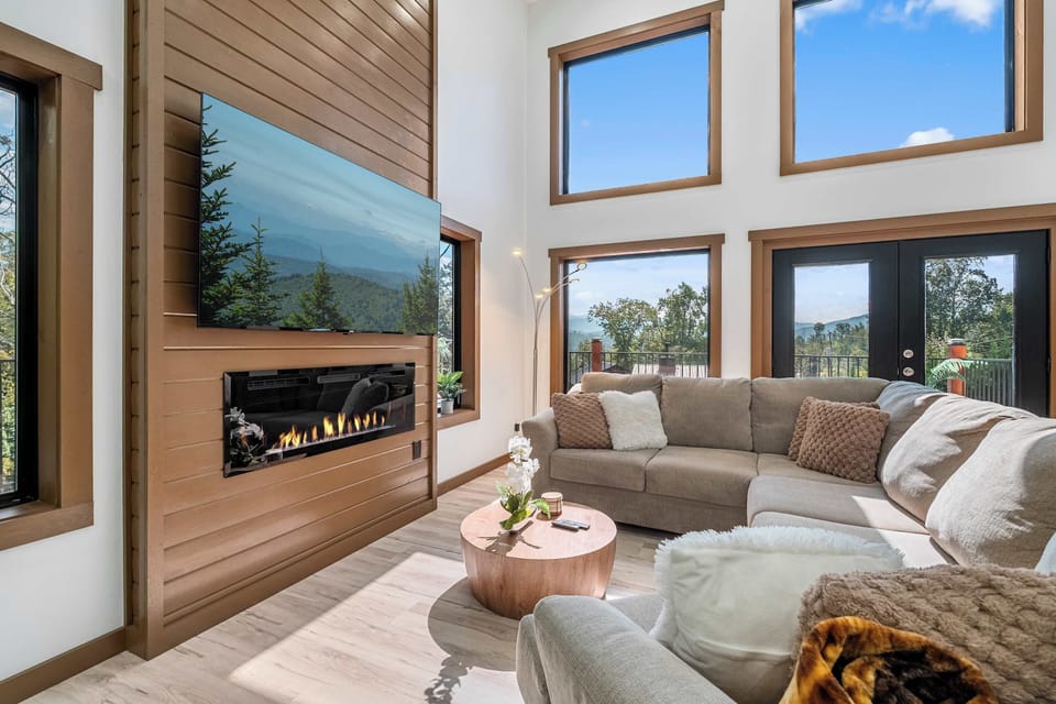 Spacious and Airy Living Room with Large Sectional and an Electric Fireplace