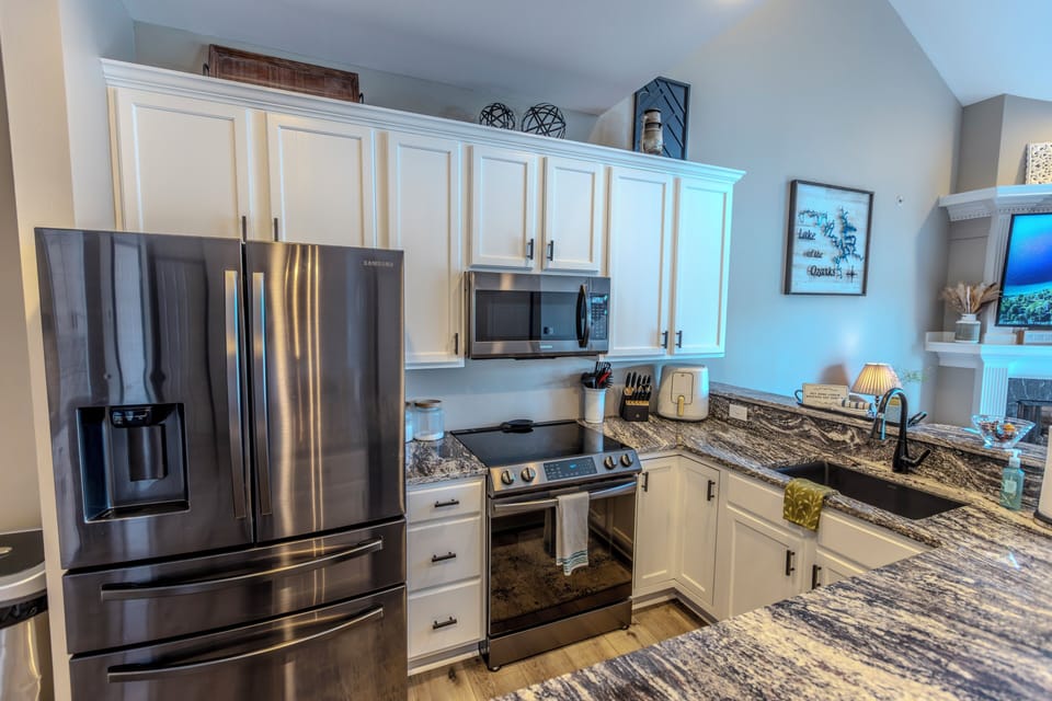 Large kitchen loaded with dishes, pots, pans, and supplies