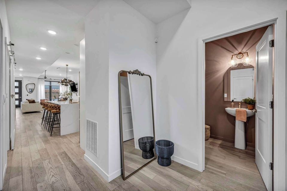 The unit showcases an efficient and well-thought-out design where the bathroom pathway feels natural, spacious, and never intrusive to the living areas.