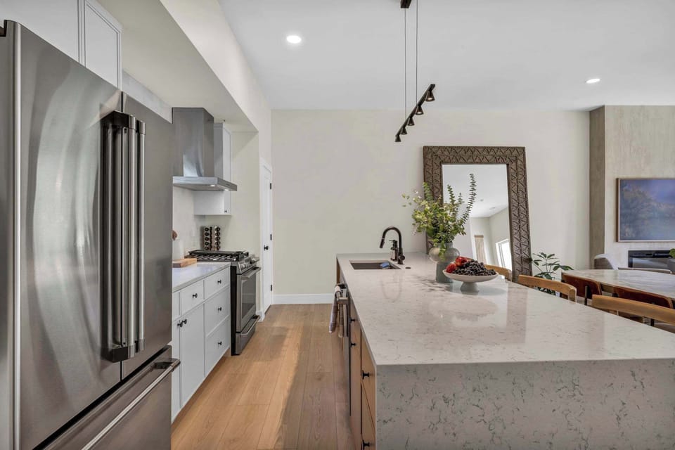 Sleek modern kitchen with oversized island and stainless steel appliances designed for effortless home-style cooking.