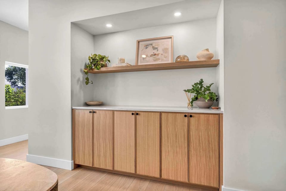 Sleek built-in storage with natural wood cabinetry and modern styling adding both function and elegance to the space.