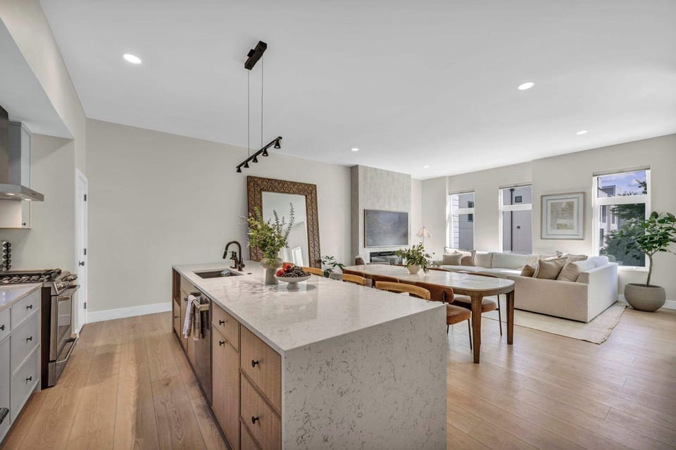 Spacious open-concept kitchen and living area with contemporary design ideal for gathering and entertaining together.