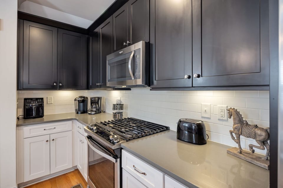 Kitchen equipped with gas stove, toaster, coffee makers, air-frier, and more.