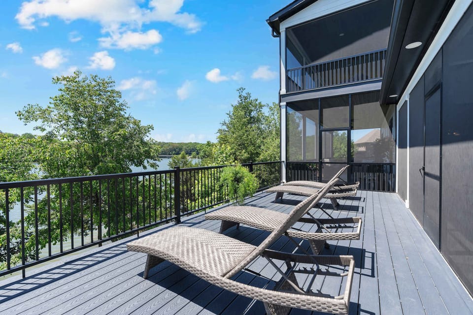 Unwind on the sun-soaked deck with stunning lake views and plush lounge chairs!