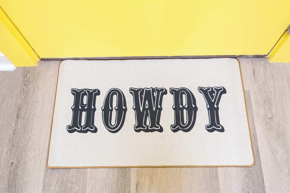 Entryway: Step into Nashville charm with a vibrant "Howdy" mat welcoming your adventure!