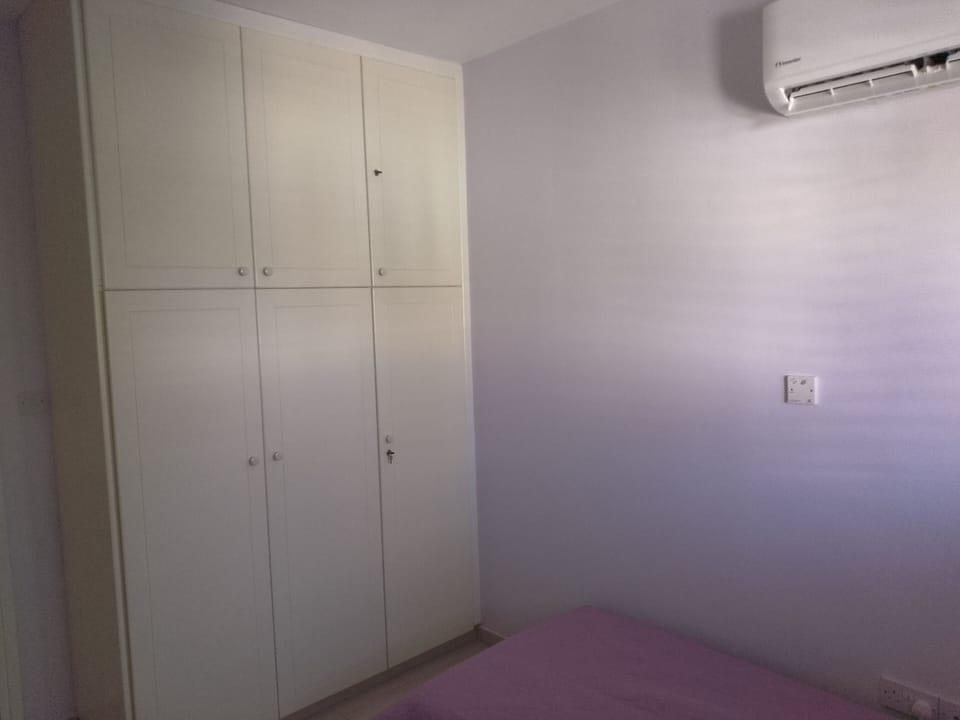 Front Bedroom-Wardrobes With Spare Towels And Bedding
