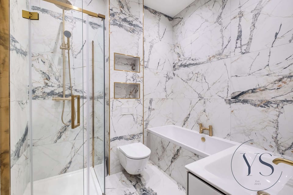Luxurious bathroom with marble tiling, walk-in shower