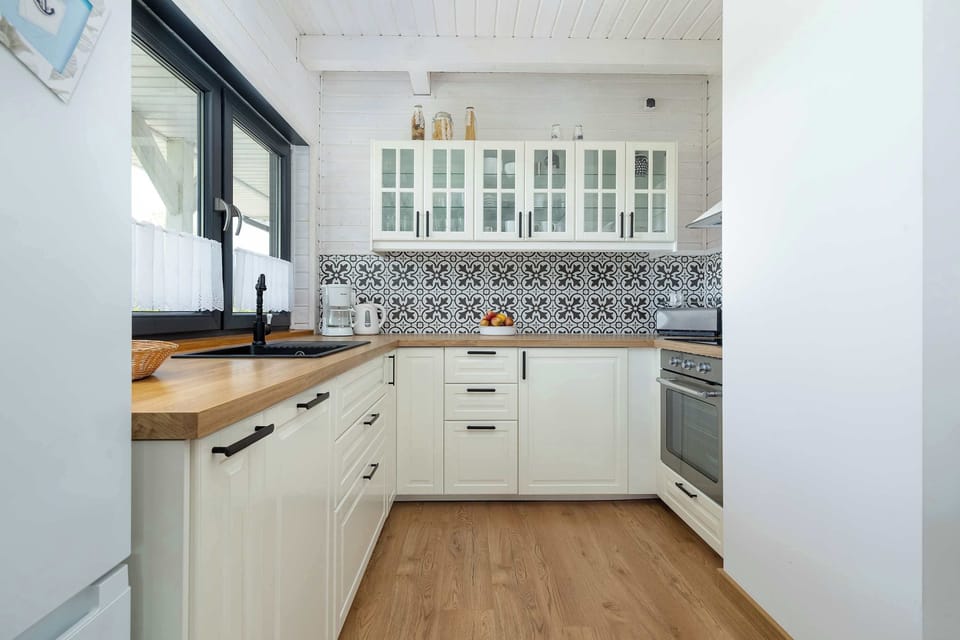Another angle of the same kitchen, focusing on the sink and window above it.