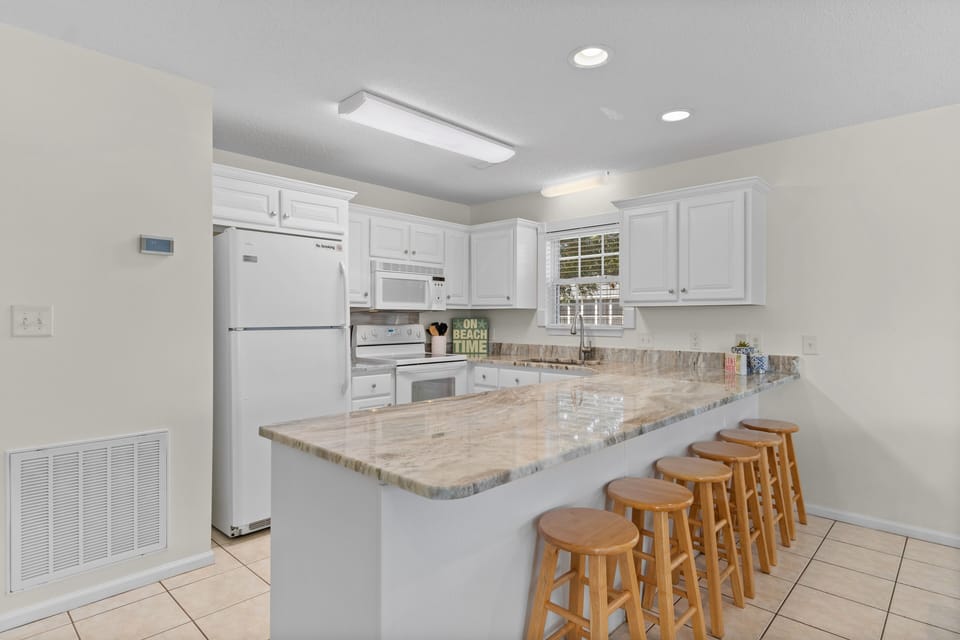 Gather around your spacious kitchen island with gleaming granite counters, where morning coffee and evening conversations flow naturally together.
