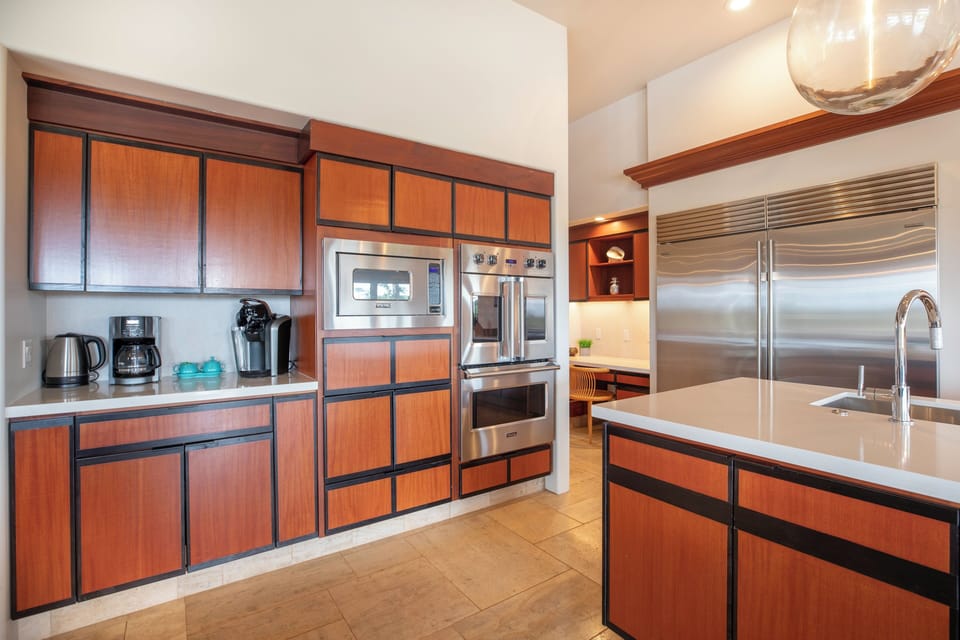 Your gourmet kitchen features sleek wood cabinetry and top-tier stainless steel appliances for effortless cooking during your stay.