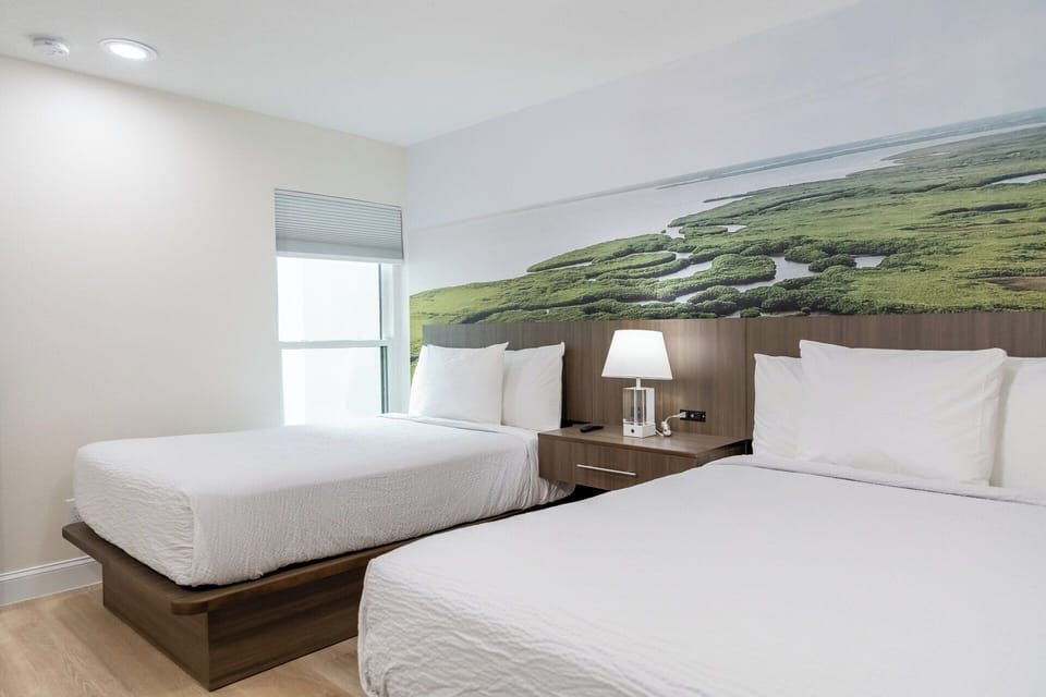 Stretch out comfortably in a bright room with two plush beds.