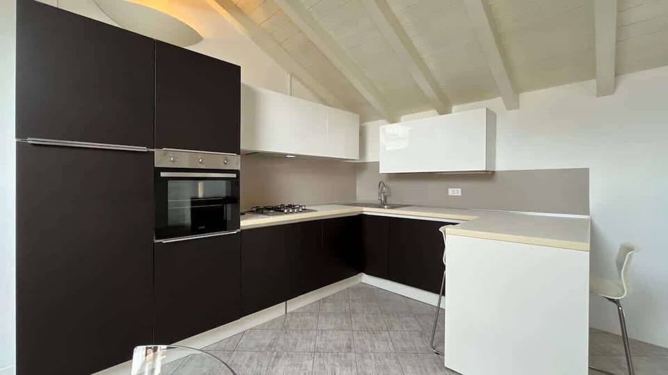 Modern and elegant kitchen equipped with all essential appliances, featuring a large workspace and a comfortable peninsula with seating