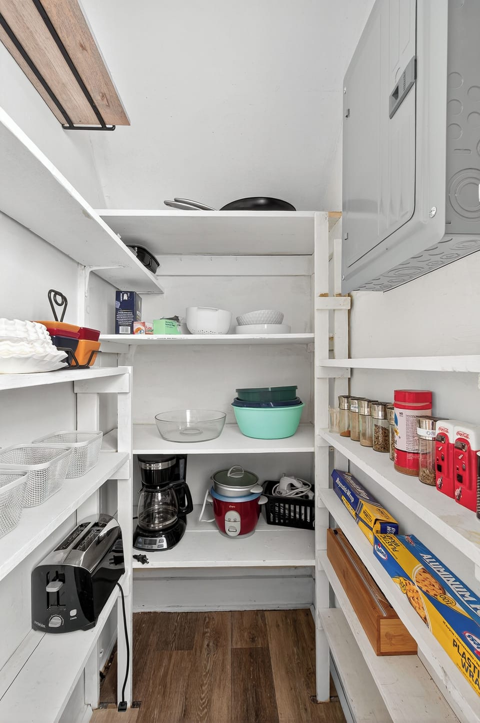 Pantry with small appliances and a drip coffee maker and filters.