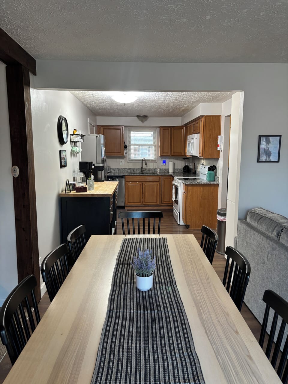 Extra long dining table comfortably seats eight with easily access from Kitchen.