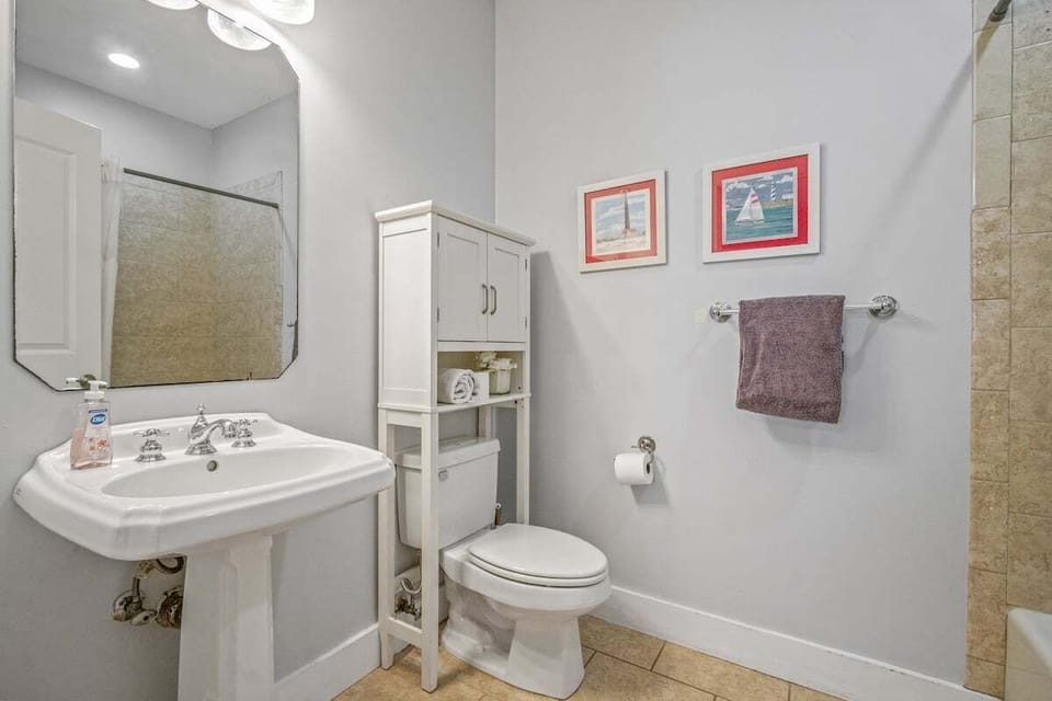 A sleek tile shower in the en-suite of the first-floor king bedroom, offering a modern and refreshing space to relax and rejuvenate!