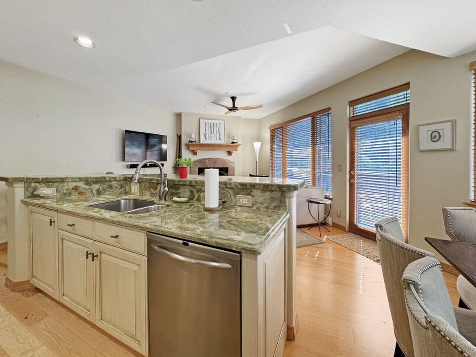 Gather around this spacious kitchen island - perfect for morning prep while others sip coffee at the counter seating. The open flow to the living area and patio views create an inviting heart of the home for your group