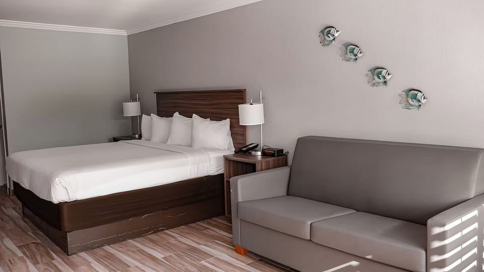 Sink into crisp linens beside a cozy sitting area.