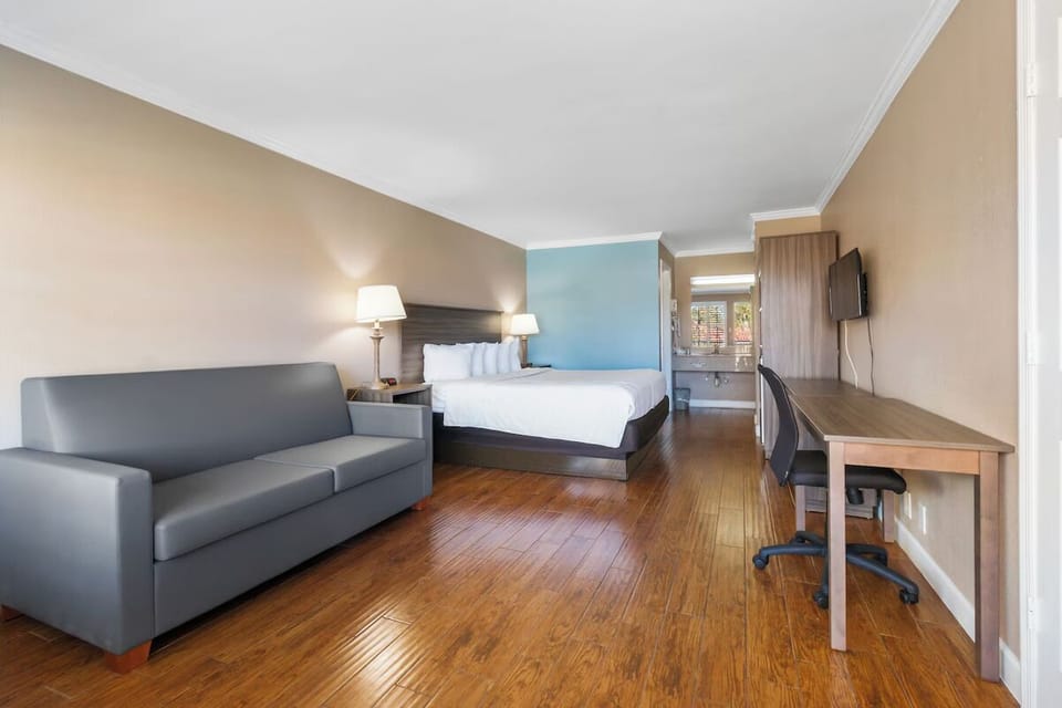 Unwind on plush bedding with sofa lounge and workspace.