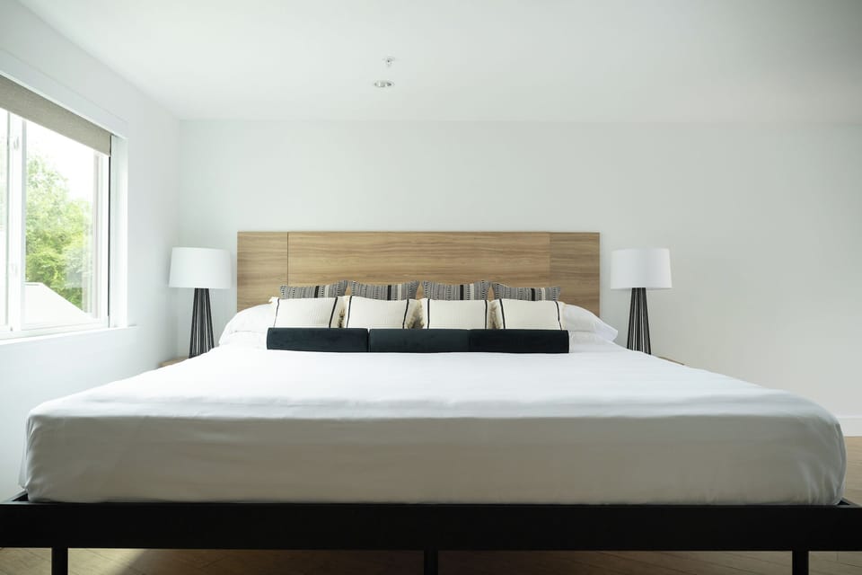 Wake up refreshed beside soft daylight and crisp white linens.