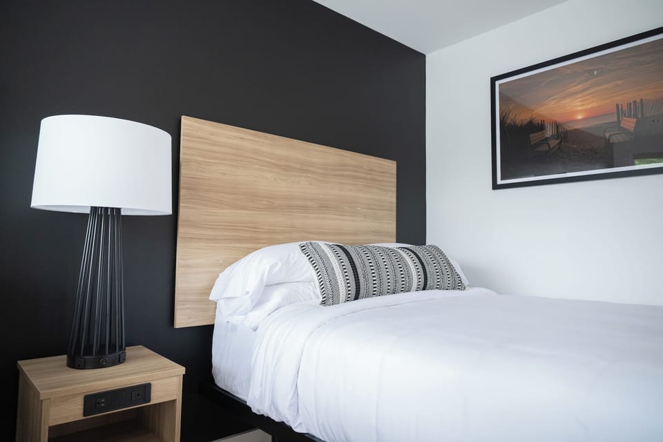Recharge beside a cozy lamp and smooth, cloudlike linens.
