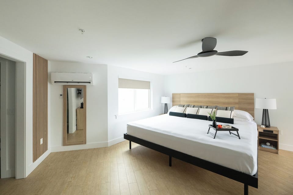 Stretch out on crisp linens beneath a quiet, modern ceiling fan.