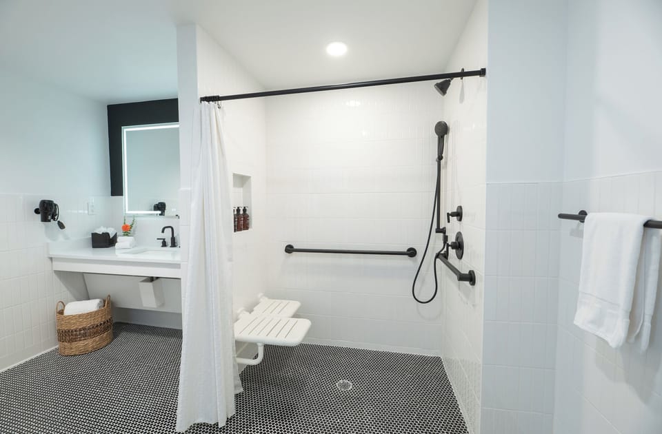 Refresh under the spacious roll-in shower with luxe fixtures.