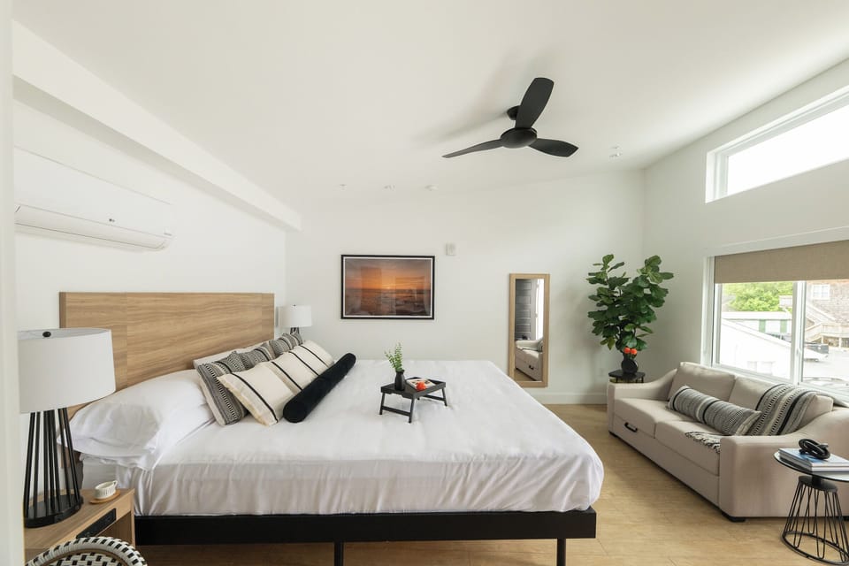 Unwind in the airy king bedroom with cozy lounge sofa.