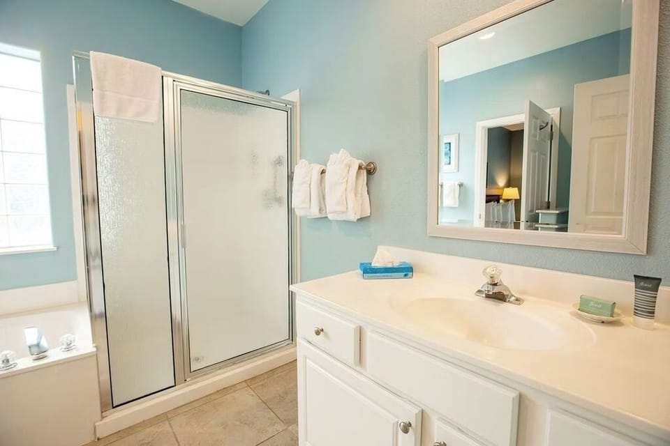 Rinse off in a bright, spotless bath with roomy vanity.