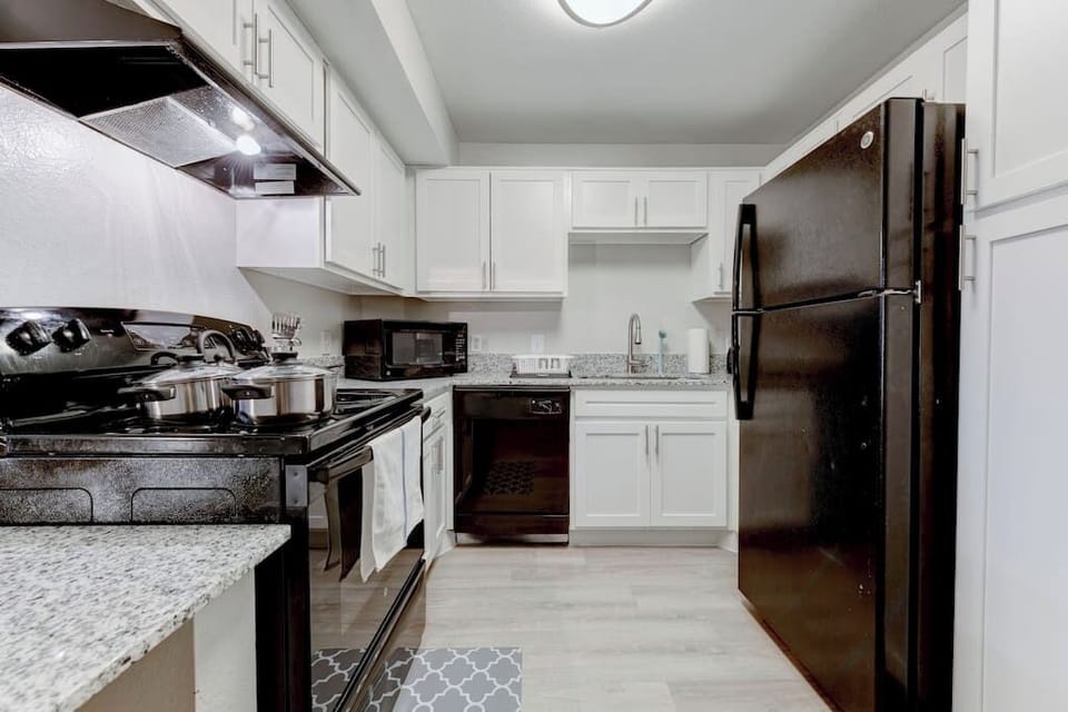 Full kitchen view w/ stainless appliances and generous counter space