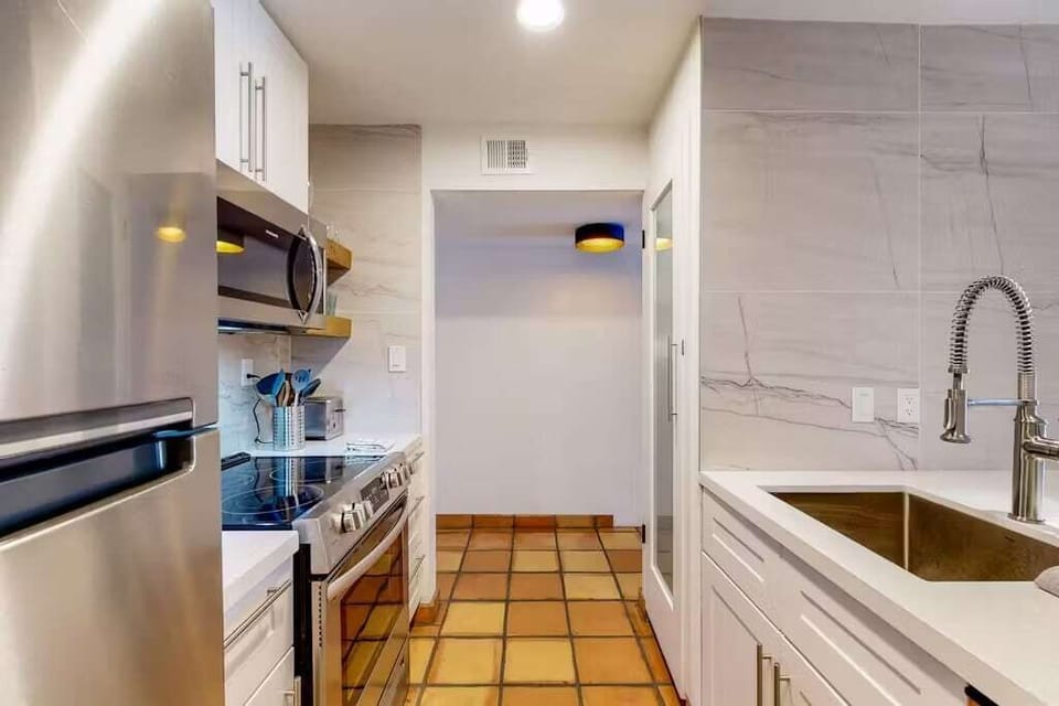 Fully Equipped Kitchen with Stainless Steel Appliances, sleek floating shelves