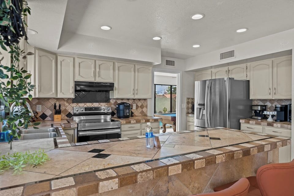 Enjoy the convenience of top-notch appliances, ample counter space, and a cozy dining area for shared culinary experiences.