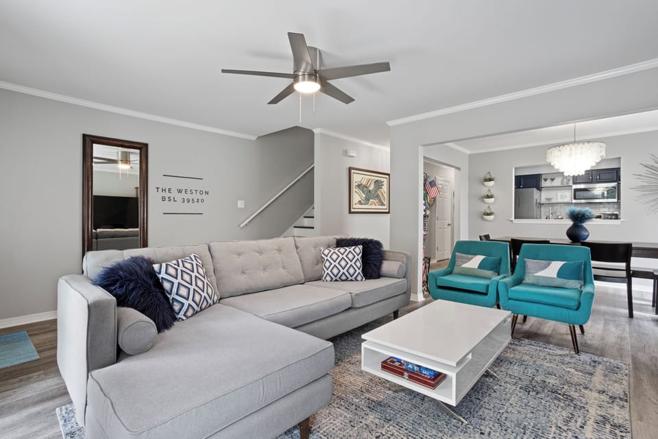 Spacious, comfy living room with 82" Smart TV.