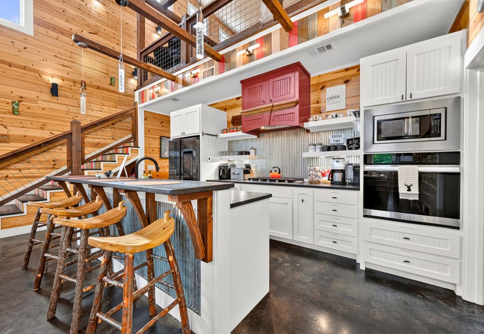 The fully equipped kitchen offers generous counter space, modern appliances, and bar seating that makes meal prep a social experience.