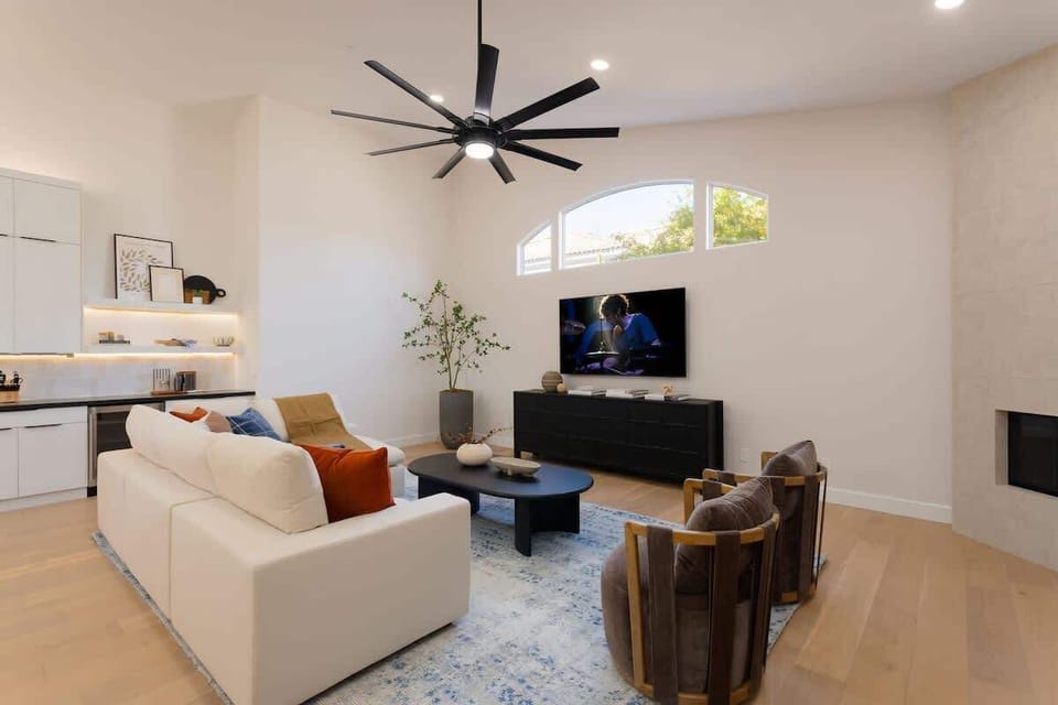 Main living area featuring designer furnishings, a Smart TV, and a fireplace.