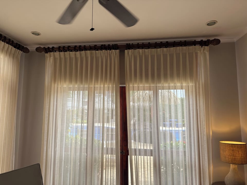 Living room looking out on pool with AC and Fan