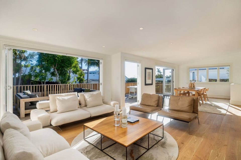 Sunny spacious open plan living and dining with bi-fold doors opening out to the sunny deck and back lawn.