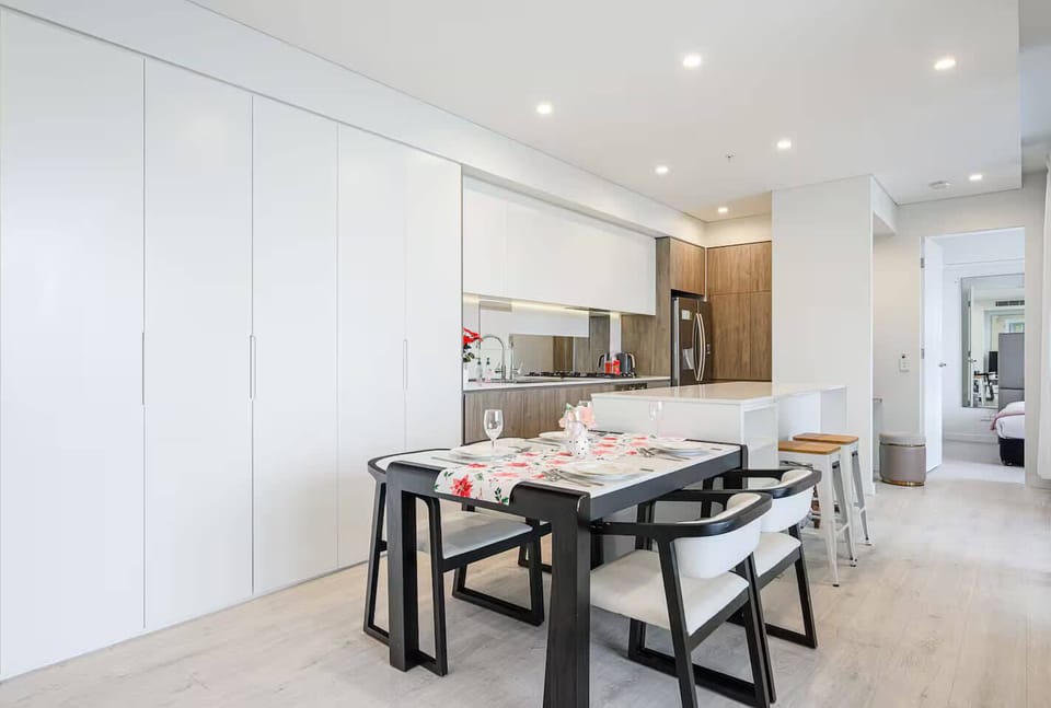 Dining area with table setting and seating for multiple guests.