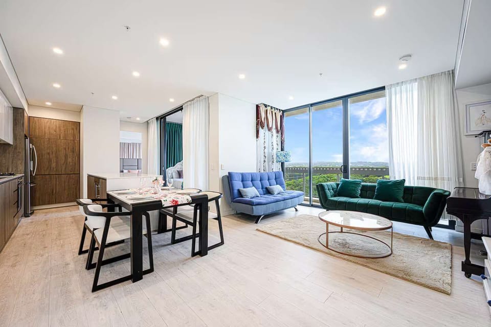 Open-plan living and dining area showcasing lounge seating and the sofa bed in the living space.