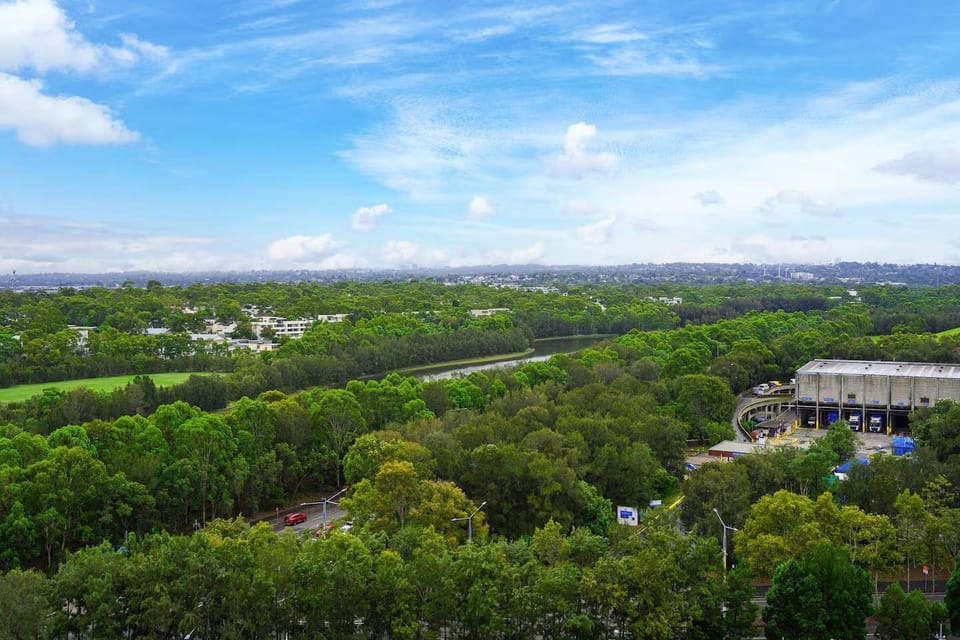 Patio view overlooking lush greenery and surrounding skyline.