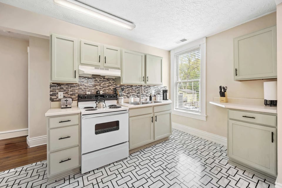 Kitchen: Bright, clean, and full of character! This kitchen offers a welcoming space for all your culinary adventures.