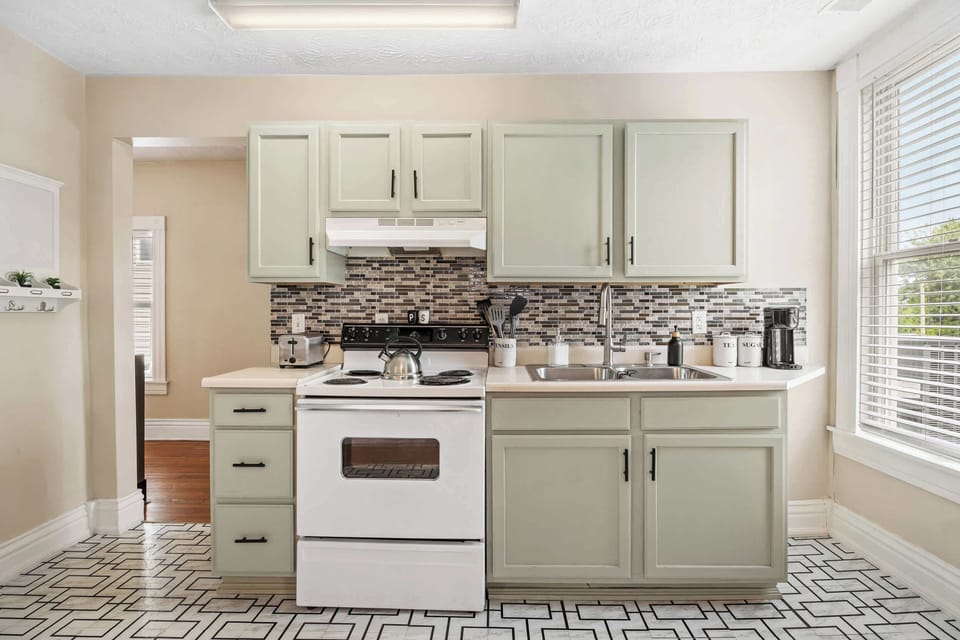 Kitchen: Bright, clean, and full of character! This kitchen offers a welcoming space for all your culinary adventures.