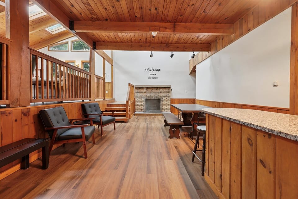 Dine together at the elegant wooden table with sweeping views of the vaulted great room.