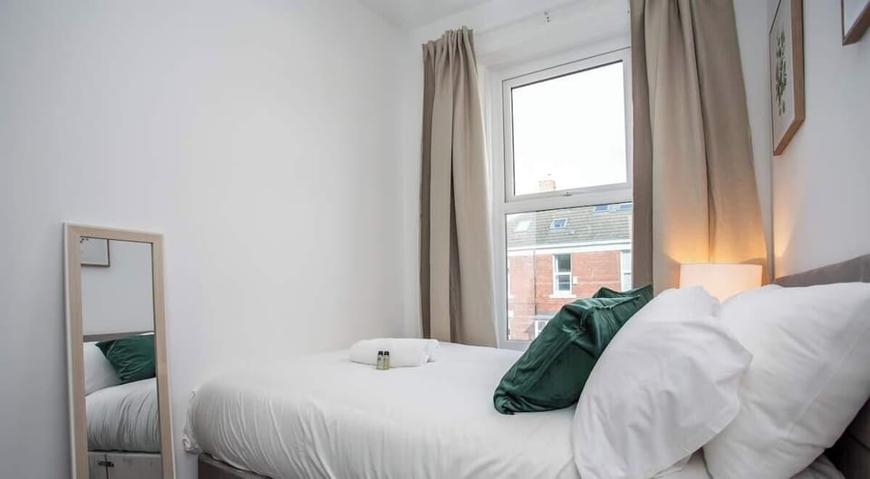 Cozy bedroom with a plush double bed, soft linens, and natural light for a restful night’s sleep