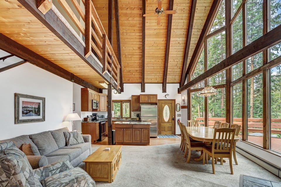 Floor to ceiling windows offer stunning mountain views in this open floor plan chalet 