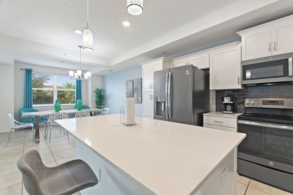 Spacious open kitchen with large island and seating near Disney – Shine Villas | Sunset Retreat, Storey Lake Resort, Orlando