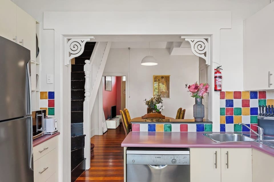 Prepare fresh local produce in the fully equipped kitchen, featuring a gas stove, oven, microwave, and dishwasher, along with a Nespresso machine, toaster, and fridge for effortless home-style meals.