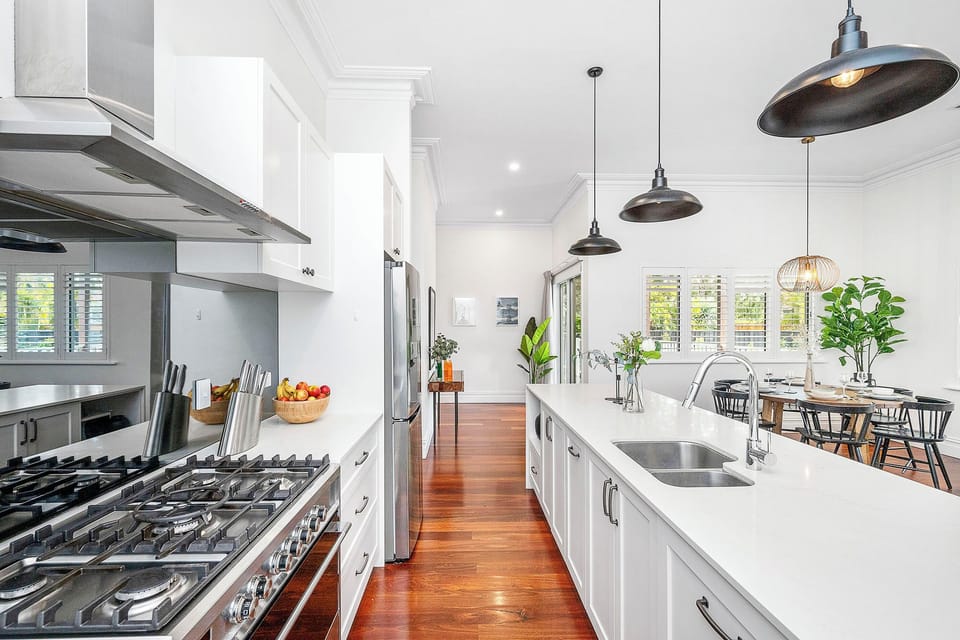 Bright open-plan space with a long island and round dining table.
