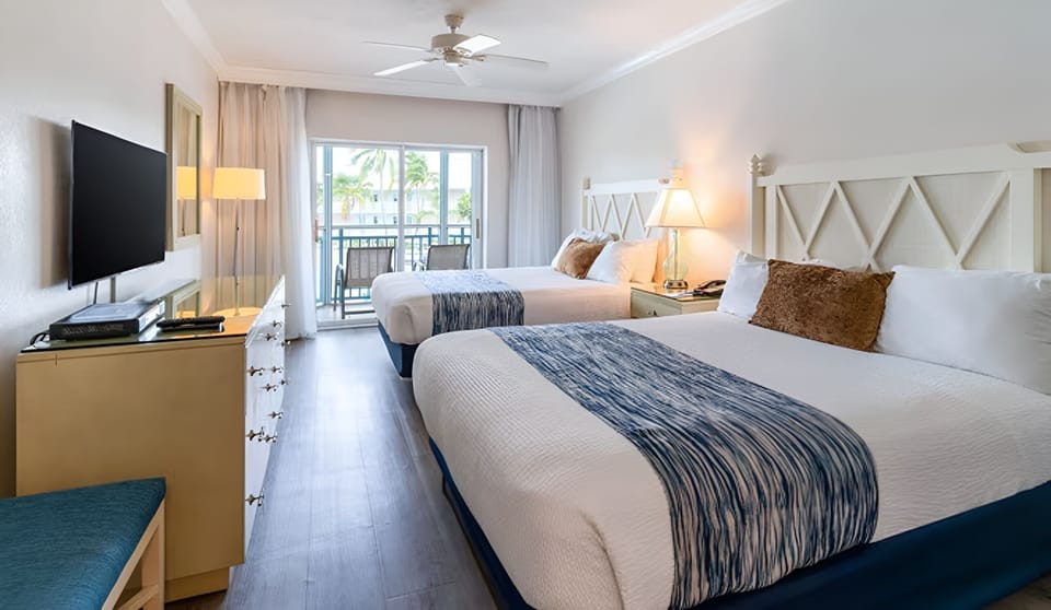 Wake up in a bright bedroom with balcony views ahead.