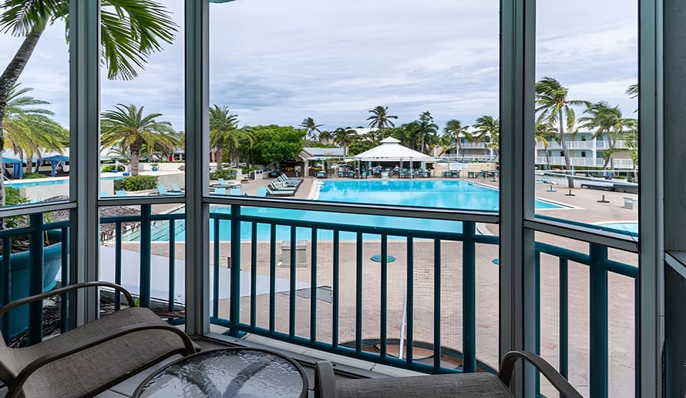 Sip morning coffee overlooking the sparkling pool and palms.