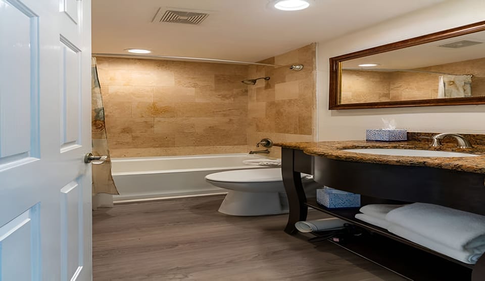 Refresh after the beach with a deep tub and granite vanity.